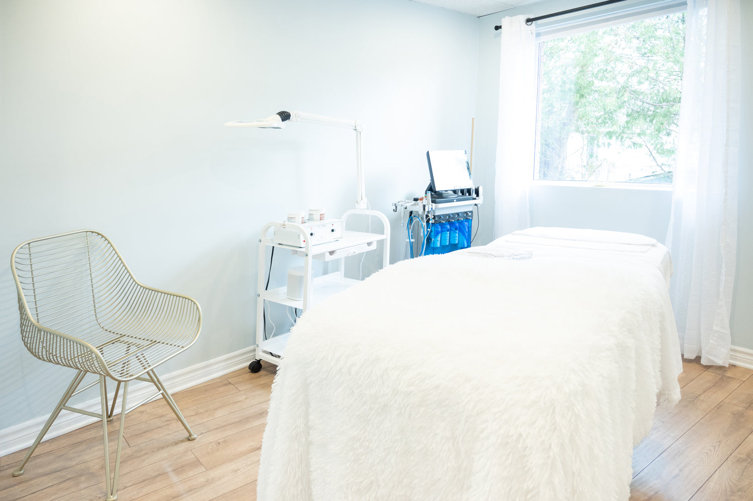Photo of a cozy blanket on a bed at a spa in a facial treatment room at Vie Esthetic Studio. Clean, bright, relaxing. 